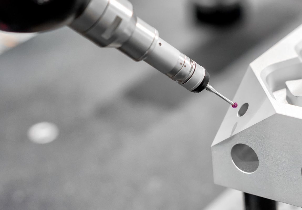 Precision measurement probe inspecting a machined metal component